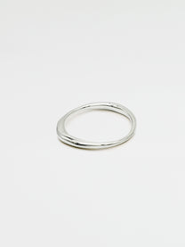 A single silver ring with an irregular band design, displayed against a white background.