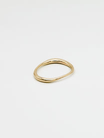 Irregular, organic, fine gold band on white background