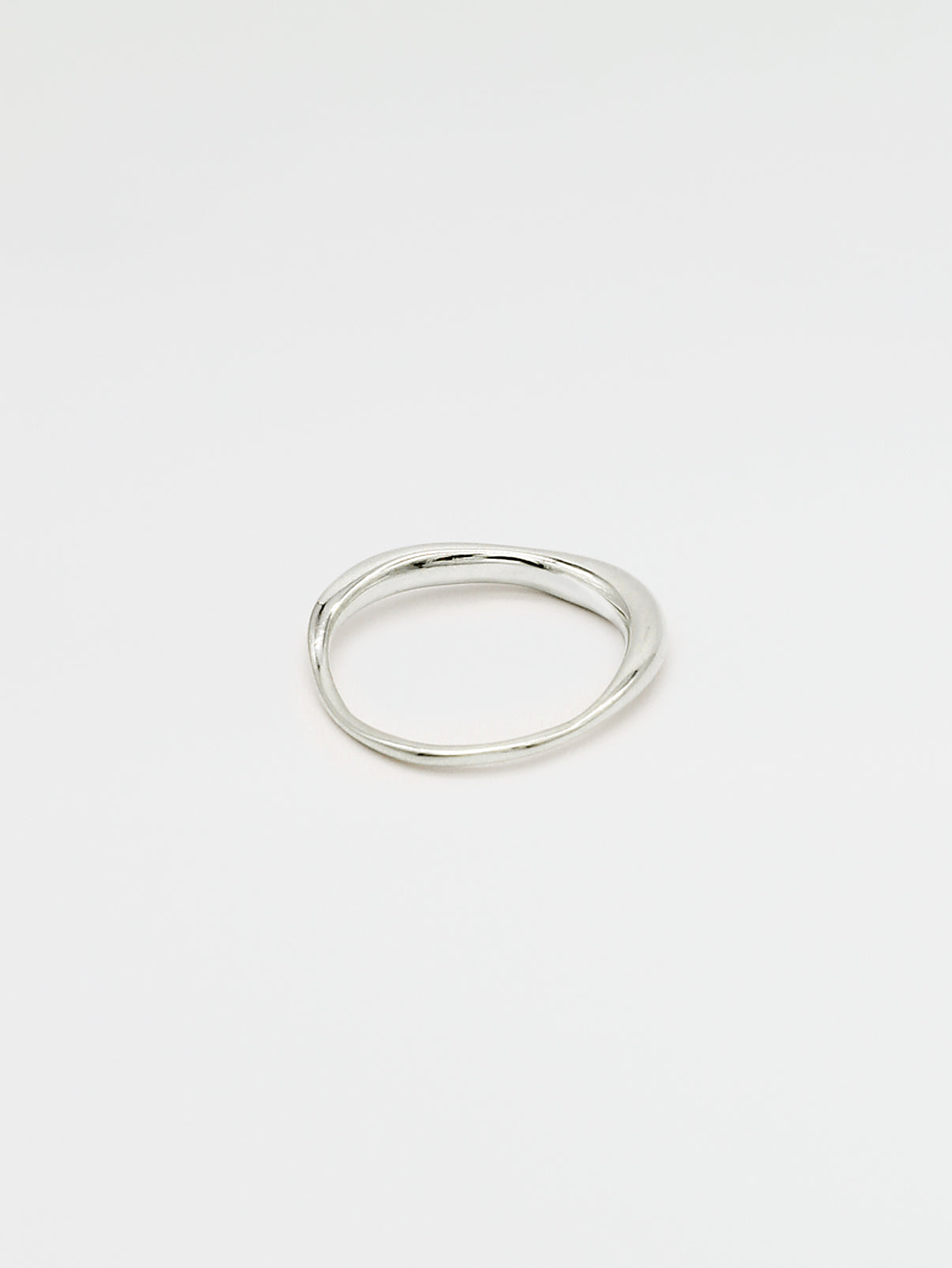 A fine silver ring with a carved, irregular design, displayed on a plain white background.