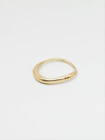 A fine gold ring with a carved, irregular design, displayed on a plain white background.