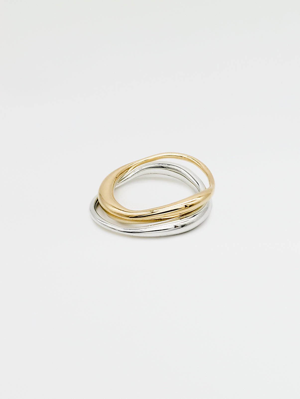 A fine gold ring with a carved, irregular design, displayed on a plain white background.