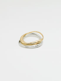 A fine gold ring with a carved, irregular design, displayed on a plain white background.