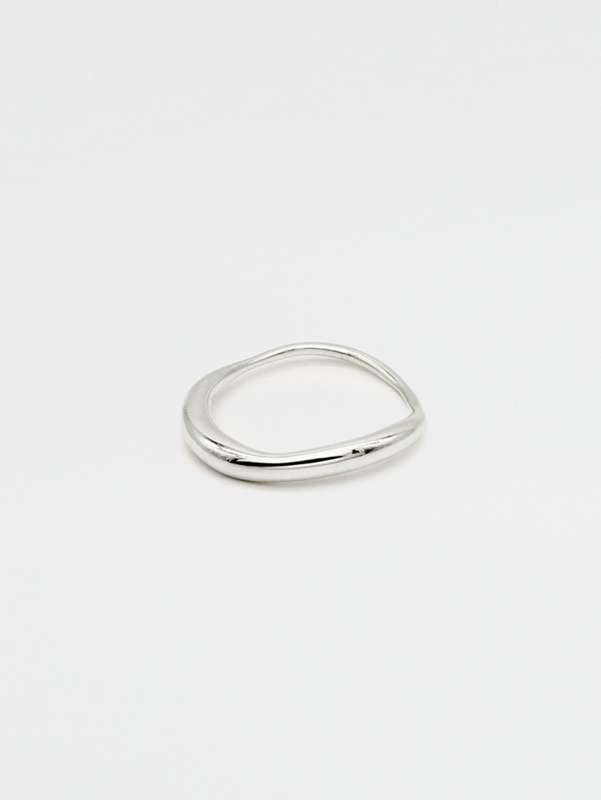 A fine silver ring with a carved, irregular design, displayed on a plain white background.