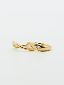 Two gold ring bands, one with an oval diamond, on white background.
