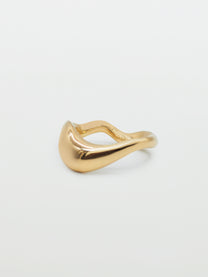 Wavy bold gold ring on white background