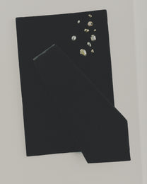 Black fabric with mixed stud earrings on a white background