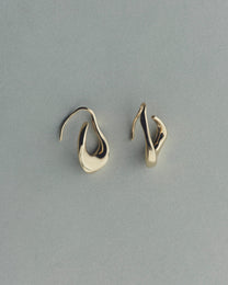 Pair of gold earrings on a gray background