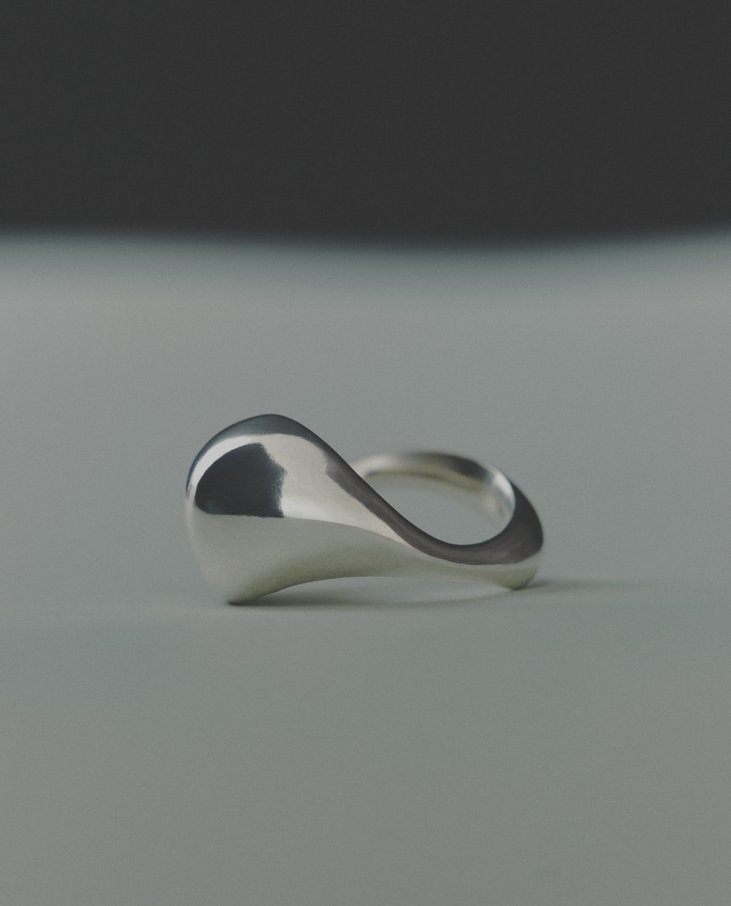 Silver ring with a domed design on a gray background