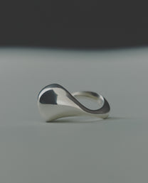 Silver ring with a domed design on a gray background
