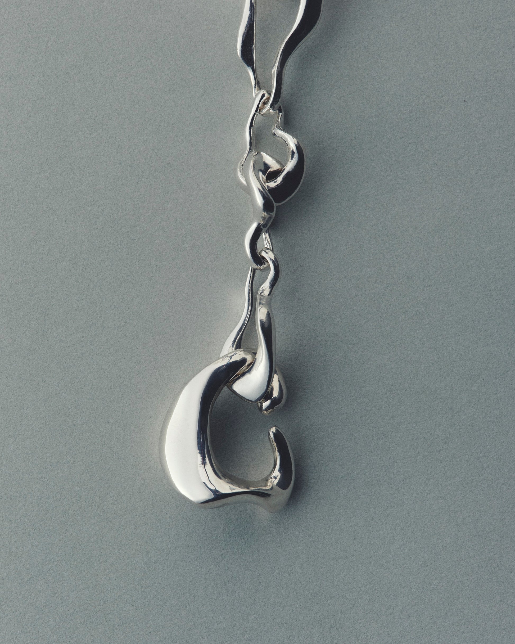 Silver bracelet with a unique design on a gray background