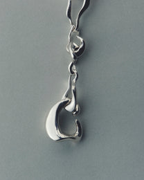 Silver bracelet with a unique design on a gray background