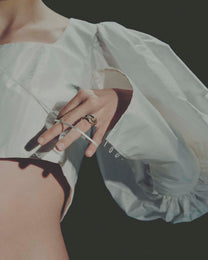 Close-up of a hand wearing a ring with a white background